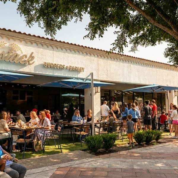 Haystack Burgers & Barley restaurant with outdoor patio seating and people dining and waiting.